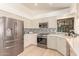 Modern kitchen with stainless steel appliances, custom cabinetry, and stylish backsplash at 6325 E Helm Dr, Scottsdale, AZ 85254