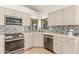 Well-equipped kitchen featuring modern appliances, granite countertops, and bright natural light at 6325 E Helm Dr, Scottsdale, AZ 85254