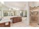 This bathroom features double sinks, a soaking tub, and a glass enclosed shower at 6325 E Helm Dr, Scottsdale, AZ 85254