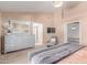 This main bedroom boasts neutral decor, an upholstered chaise, and a large dresser at 6325 E Helm Dr, Scottsdale, AZ 85254