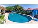 Inviting pool with blue accents, lush landscaping, a cabana, and comfortable seating creating a serene outdoor retreat at 6325 E Helm Dr, Scottsdale, AZ 85254