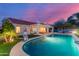 A refreshing backyard pool featuring shimmering water, unique hanging chairs, and a well-kept garden at 6325 E Helm Dr, Scottsdale, AZ 85254
