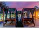 Relax poolside in the cabana-style beds overlooking the pool, perfect for enjoying a summer evening at 6325 E Helm Dr, Scottsdale, AZ 85254