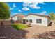 A private backyard with artificial turf, desert rock landscaping, and covered patio at 6425 S Kimberlee Way, Chandler, AZ 85249