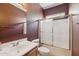Compact bathroom with shower-tub combo, single sink vanity and brown accent wall at 6425 S Kimberlee Way, Chandler, AZ 85249