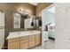 Bathroom featuring double sinks and an open doorway to the main bedroom at 6425 S Kimberlee Way, Chandler, AZ 85249
