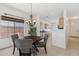Elegant dining area with stylish chandelier and views into the kitchen through a pass-through at 6425 S Kimberlee Way, Chandler, AZ 85249