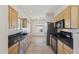 Well-lit kitchen featuring stainless steel appliances, light wood cabinetry, and a spacious layout at 6425 S Kimberlee Way, Chandler, AZ 85249