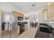 Modern kitchen features stainless steel appliances, light wood cabinetry, and granite countertops at 6425 S Kimberlee Way, Chandler, AZ 85249