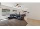 Spacious living room featuring plush seating and an adjacent dining area with modern chandelier at 6425 S Kimberlee Way, Chandler, AZ 85249