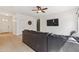 Cozy living room area with a ceiling fan, mounted TV, and open access to other rooms at 6425 S Kimberlee Way, Chandler, AZ 85249