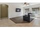 Comfortable living room with a plush sectional, ceiling fan, and abundant natural light from large windows at 6425 S Kimberlee Way, Chandler, AZ 85249