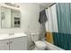Clean bathroom with a white vanity, standard toilet, and a shower/tub with a colorful curtain at 6541 N 41St Ave, Phoenix, AZ 85019