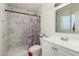 Updated bathroom showcasing modern tile work, a floral shower curtain, and a vanity at 6541 N 41St Ave, Phoenix, AZ 85019