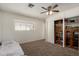 Well-organized bedroom featuring a window, carpet, and a built-in closet for storage at 6541 N 41St Ave, Phoenix, AZ 85019