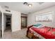 Bright bedroom with a window, ornate bed frame, neutral carpet, and some furniture pieces at 6541 N 41St Ave, Phoenix, AZ 85019