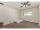 Cozy carpeted bedroom featuring a ceiling fan, a single window, and a minimalist bed at 6541 N 41St Ave, Phoenix, AZ 85019