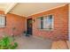 Welcoming covered front entrance with brick walls, wrought iron window guards, and a potted plant at 6541 N 41St Ave, Phoenix, AZ 85019