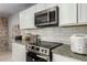Close-up of a modern kitchen featuring stainless steel appliances, white subway tile, and granite countertops at 6541 N 41St Ave, Phoenix, AZ 85019