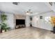 Bright and airy living room with light wood floors, a stone accent wall, and abundant natural light at 6541 N 41St Ave, Phoenix, AZ 85019
