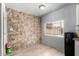 Pantry area featuring unique stone wall accents, modern flooring, and a window at 6541 N 41St Ave, Phoenix, AZ 85019