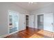 Bedroom with hardwood floors, doors leading to the bathroom, and closet at 711 E Mckinley St, Phoenix, AZ 85006