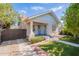 Charming bungalow with a gabled roof, brick accents, and a covered porch with light blue doors at 711 E Mckinley St, Phoenix, AZ 85006