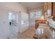 Bright kitchen with granite countertops, white cabinets, and a window overlooking the outdoors at 711 E Mckinley St, Phoenix, AZ 85006