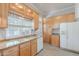 Charming kitchen featuring light wood cabinetry, granite countertops, and stainless steel appliances at 711 E Mckinley St, Phoenix, AZ 85006