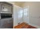 Functional laundry area with stacked washer/dryer and ample storage with a door that leads to the outdoors at 711 E Mckinley St, Phoenix, AZ 85006