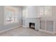 Living room featuring a fireplace with decorative shelves and large windows for natural light at 711 E Mckinley St, Phoenix, AZ 85006