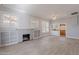 Bright living room featuring light gray walls, fireplace, built-in shelves, and hardwood floors at 711 E Mckinley St, Phoenix, AZ 85006