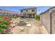 Backyard featuring block wall, covered patio, and fire pit area in a partially landscaped private setting at 742 W Agrarian Hills Dr, San Tan Valley, AZ 85143