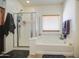 Bright bathroom features a separate shower and tub, offering a relaxing and functional space at 742 W Agrarian Hills Dr, San Tan Valley, AZ 85143