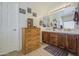 Bathroom features a double sink vanity with wood cabinets and tiled countertop, plus a large linen closet at 742 W Agrarian Hills Dr, San Tan Valley, AZ 85143