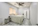 Simple bedroom with a double bed, tiled floors, neutral walls, and a large window for natural light at 742 W Agrarian Hills Dr, San Tan Valley, AZ 85143