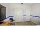 Bedroom features neutral walls, blue accent stripe, and carpet flooring, plus a closet and storage at 742 W Agrarian Hills Dr, San Tan Valley, AZ 85143