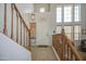 Bright foyer features a tiled floor, wooden staircase, white door, and large windows for natural light at 742 W Agrarian Hills Dr, San Tan Valley, AZ 85143