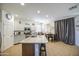 Well-lit kitchen boasts granite countertops, stainless steel appliances, a large island, and ample cabinet space for storage at 742 W Agrarian Hills Dr, San Tan Valley, AZ 85143