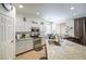 Bright kitchen featuring stainless steel appliances, granite countertops, white cabinetry, and an eat-in area at 742 W Agrarian Hills Dr, San Tan Valley, AZ 85143