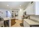 Updated kitchen features white cabinetry, granite counters, stainless steel appliances, and an island with seating at 742 W Agrarian Hills Dr, San Tan Valley, AZ 85143