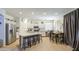 Bright kitchen features white cabinetry, stainless appliances, granite countertops, and a center island with seating at 742 W Agrarian Hills Dr, San Tan Valley, AZ 85143