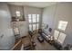 Open-concept living room features tall ceilings, large windows, a ceiling fan, and stairs to upper level at 742 W Agrarian Hills Dr, San Tan Valley, AZ 85143