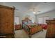Luxurious primary bedroom features a grand bed, stylish furnishings, and a ceiling fan for added comfort at 742 W Agrarian Hills Dr, San Tan Valley, AZ 85143
