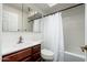 Cozy bathroom featuring a wood vanity, mirror, and a shower-tub combination with a white shower curtain at 7740 E Heatherbrae Ave # 3, Scottsdale, AZ 85251