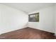 Bright bedroom with modern laminate flooring and a white brick accent wall, offering a minimalist design at 7740 E Heatherbrae Ave # 3, Scottsdale, AZ 85251