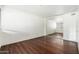 Bedroom with white brick accent wall, laminate flooring, and a mirrored closet door to maximize space at 7740 E Heatherbrae Ave # 3, Scottsdale, AZ 85251