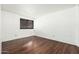 Minimalist bedroom with white brick accent wall, laminate flooring, and a window for natural light at 7740 E Heatherbrae Ave # 3, Scottsdale, AZ 85251