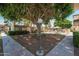 Exterior of a home with lush green trees, manicured landscaping, and walkways at 7740 E Heatherbrae Ave # 3, Scottsdale, AZ 85251