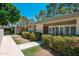 Inviting home exterior featuring lush landscaping, a well-maintained walkway, and a charming facade under a clear blue sky at 7740 E Heatherbrae Ave # 3, Scottsdale, AZ 85251